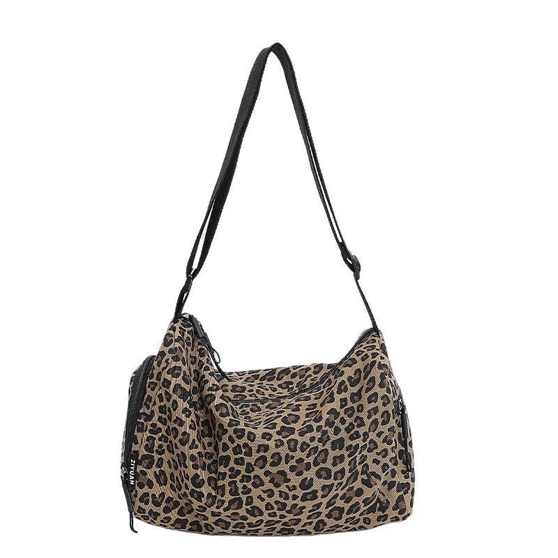 Large capacity sports style messenger bag in leopard print or striped pattern with cross-body strap