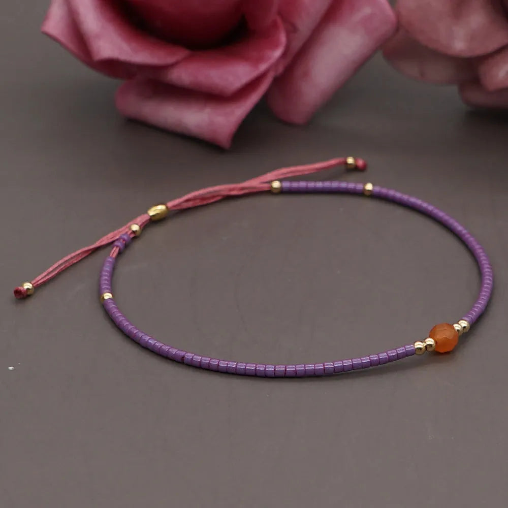 Bohemian style women's bracelet with semi-precious stone and colourful glass beads on adjustable fastening
