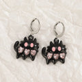 Women's alloy earrings with cross and character designs in five colour options including white cross and antique silver