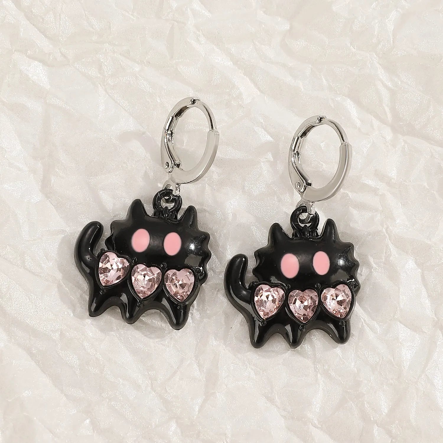 Women's alloy earrings with cross and character designs in five colour options including white cross and antique silver