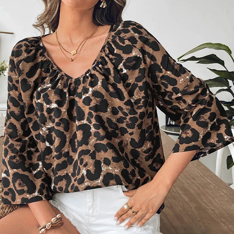 Women's multicolour leopard print V-neck pullover top with half sleeves.