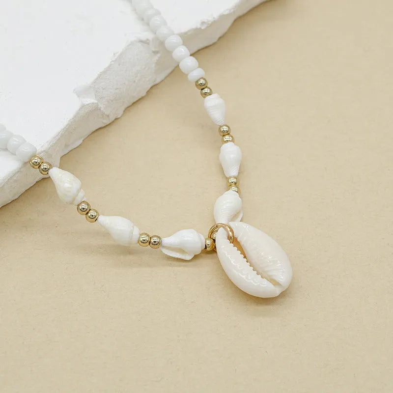 White shell necklace with mother of pearl pendant on regular chain