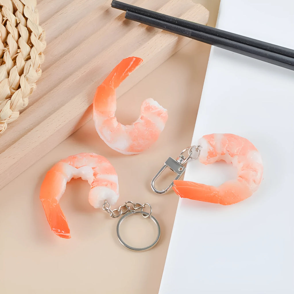 Solid PVC shrimp-shaped keychain with metal loop, 1.5cm thick, modern design.