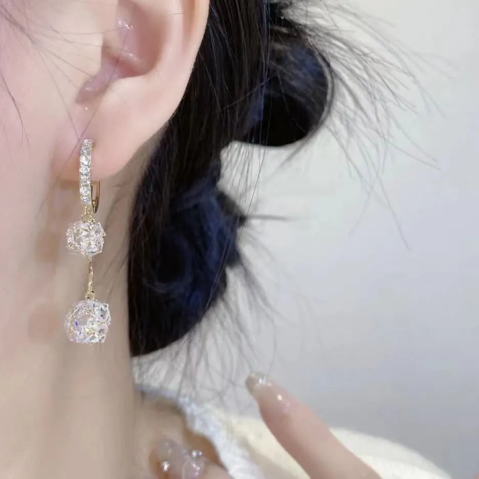 Silver drop earrings with a tassel and rhinestone ball pendant on copper findings.