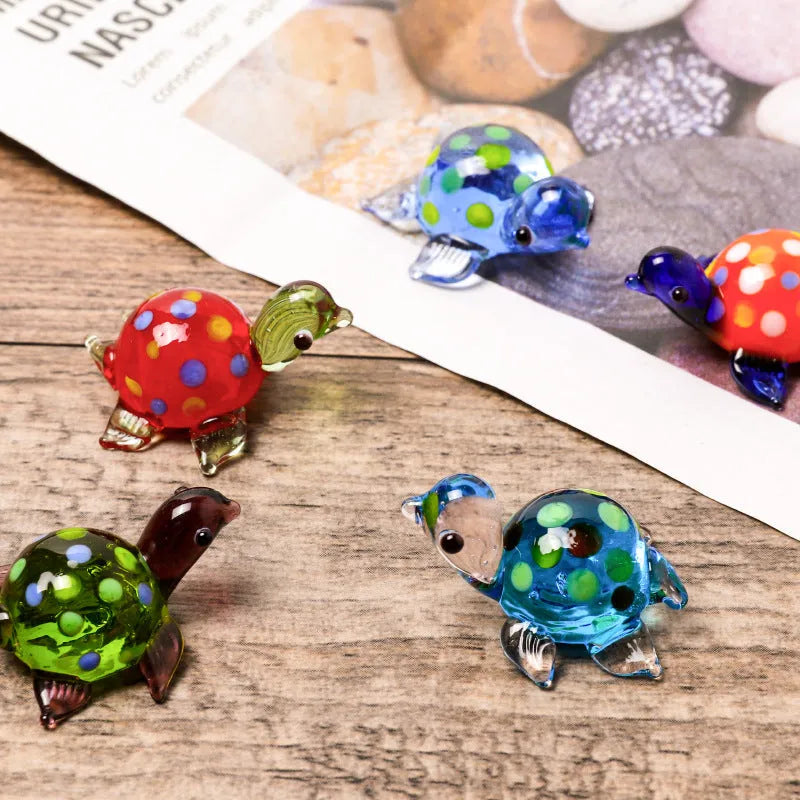 Geometric glass turtle ornament in a modern style displayed on a wooden surface.
