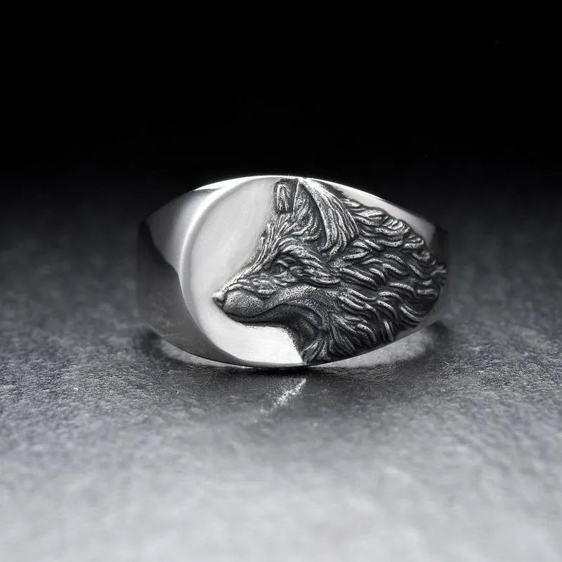 Geometric wolf head alloy signet ring in silver colour on a solid background