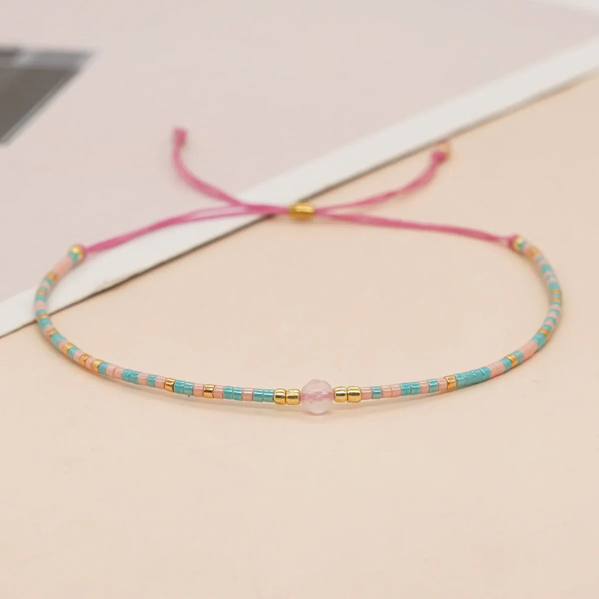 Bohemian style women's bracelet with semi-precious stone and colourful glass beads on adjustable fastening