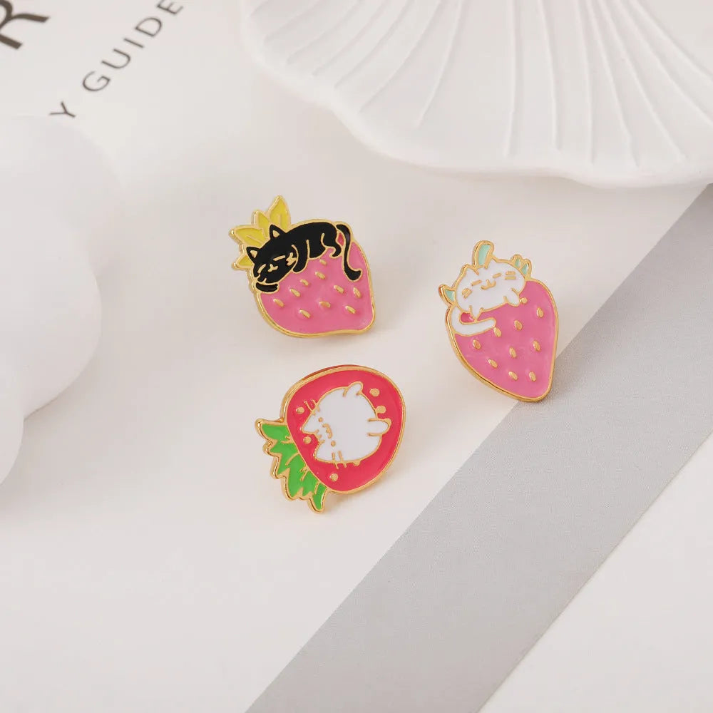 Cat strawberry metal brooch with alloy finish in five colour options on a bag