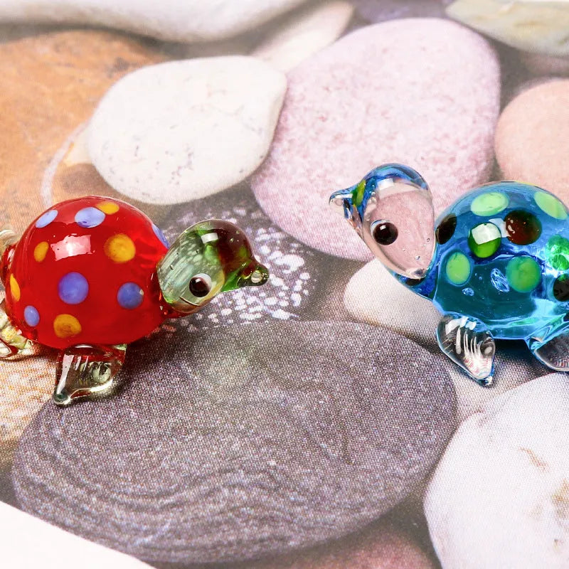 Geometric glass turtle ornament in a modern style displayed on a wooden surface.