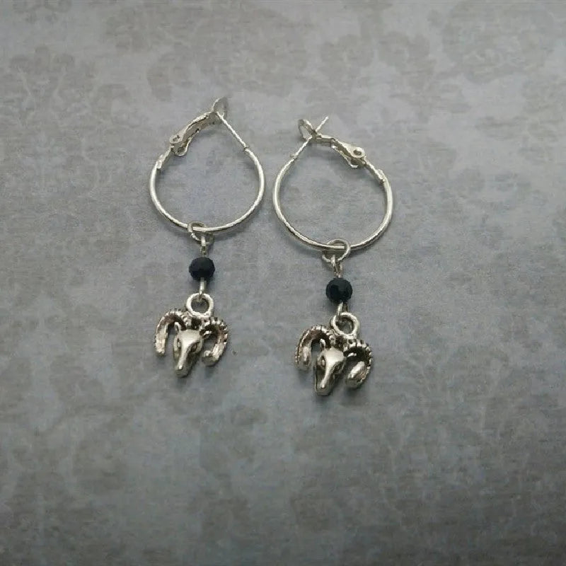 Silver round earrings with Tibetan antelope design inspired by Yunnan high altitude regions