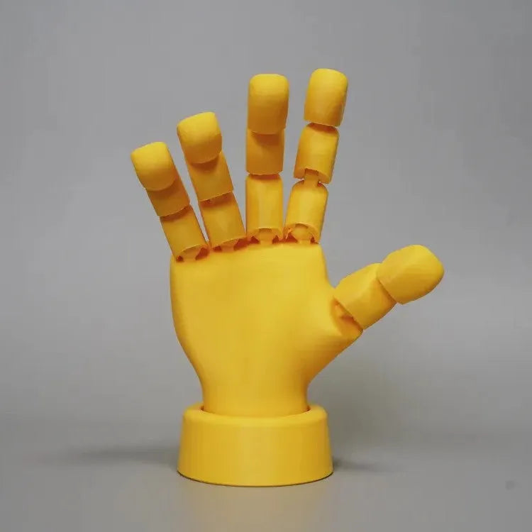 Yellow movable joint hand ornament figurine on a plain background.