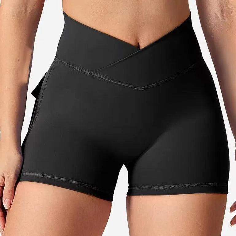Women's workout shorts with peach hip tight fit in black, front view, for running and yoga
