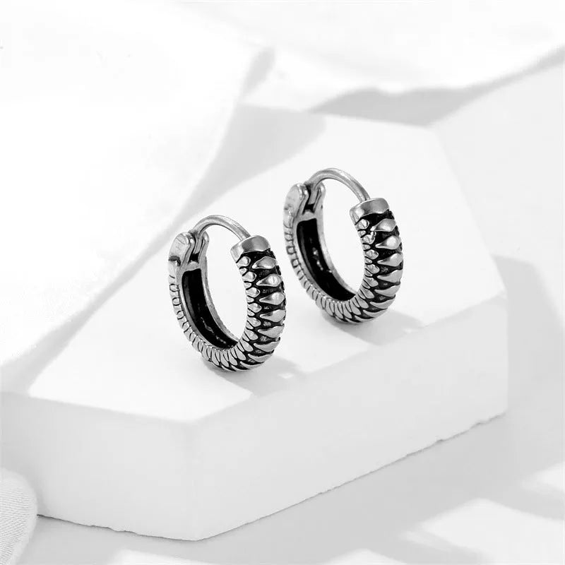 Silver titanium steel geometric twist earrings with round sports-style elements