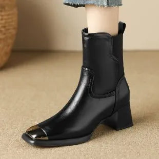 Brown women's Martin boots with high heel and side zip on a white background.