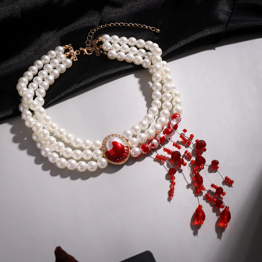 Gold electroplate Halloween pearl collar set with U-shaped necklace, bracelet, and stud earrings on display