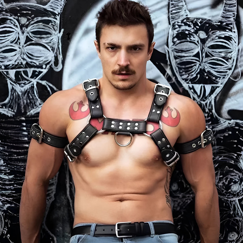 Black leather chest bondage strap with metal buckle and rivet details for cosplay and festival outfits