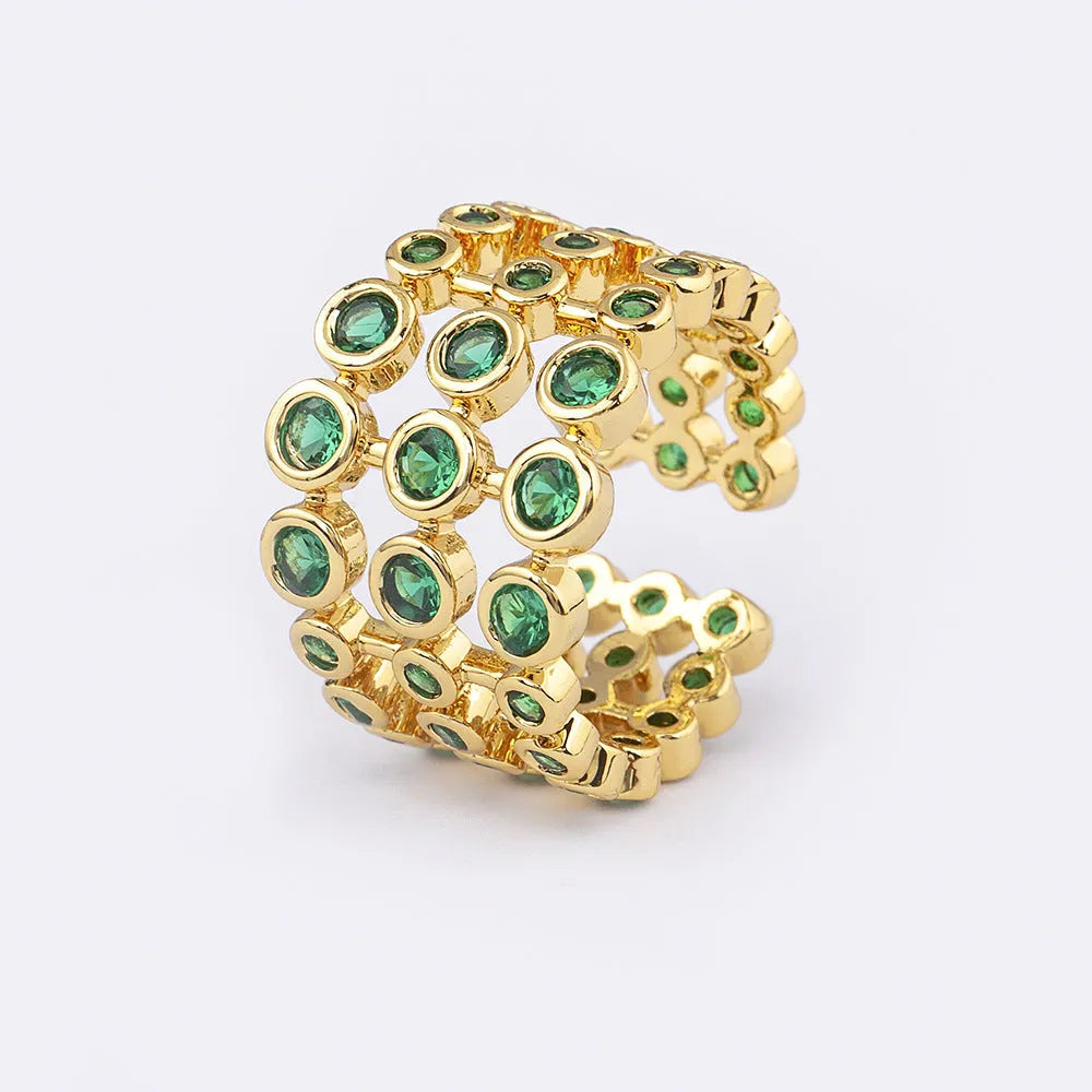 Gold coloured wide band ring with three layers of green zircons on a copper base plated with 18K real gold.