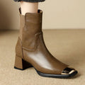 Brown women's Martin boots with high heel and side zip on a white background.