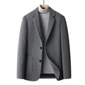 Men's solid colour slim fit wool suit jacket on a hanger.