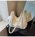 Soft PU women's fashion backpack in beige, shown with attached pendant accessory.