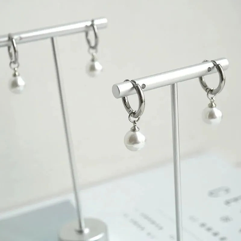 Pearl-coloured geometric round alloy earrings with dangle drop design and titanium steel posts