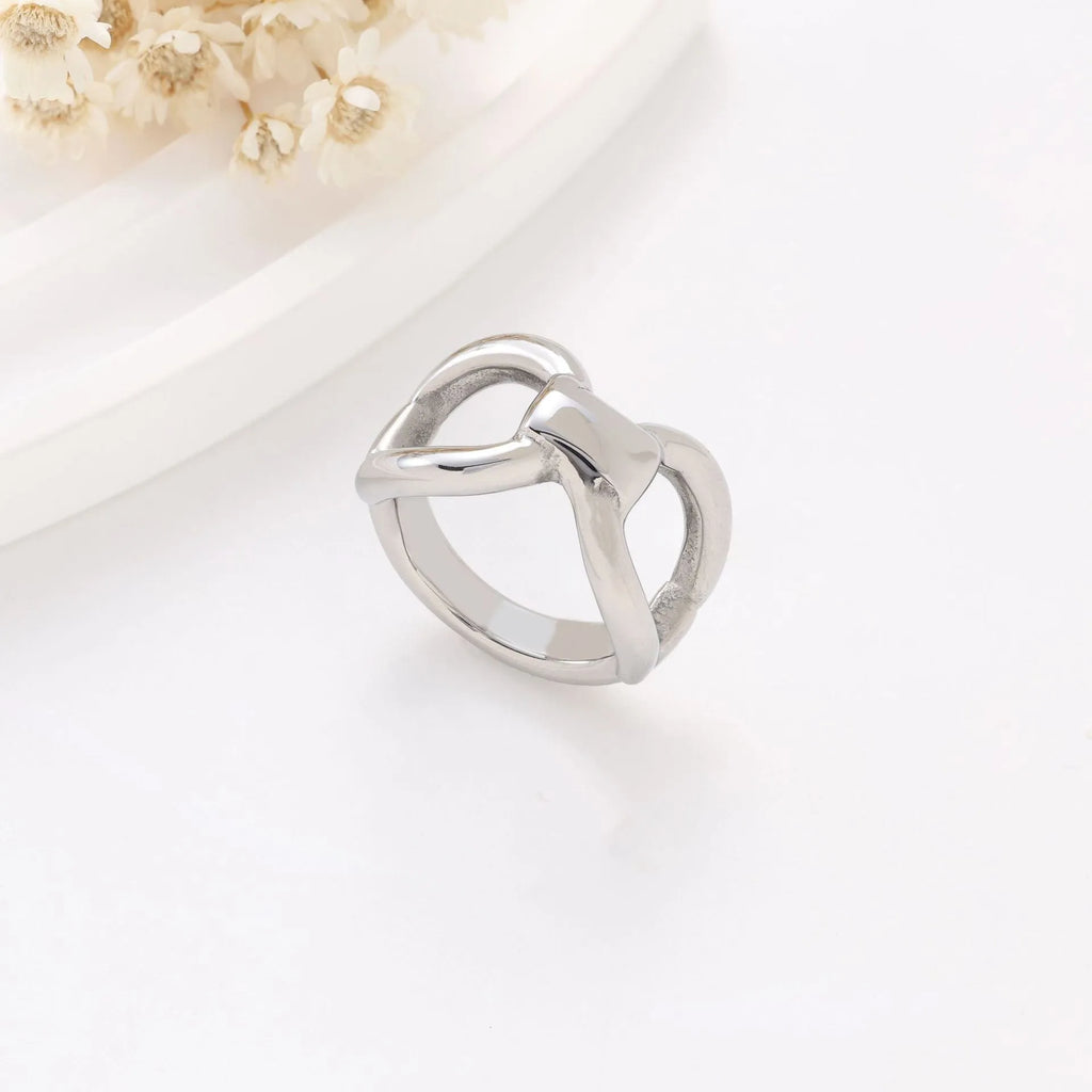 Simple fashion butterfly hollow women's ring in titanium steel gold colour on plain background
