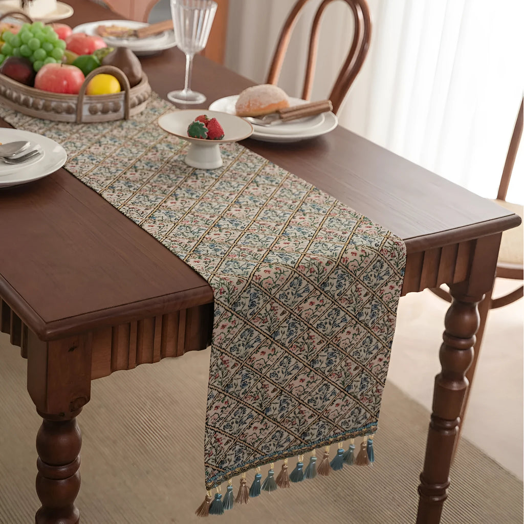 Nordic jacquard bouquet pattern table runner with tassels in dark blue on wooden table