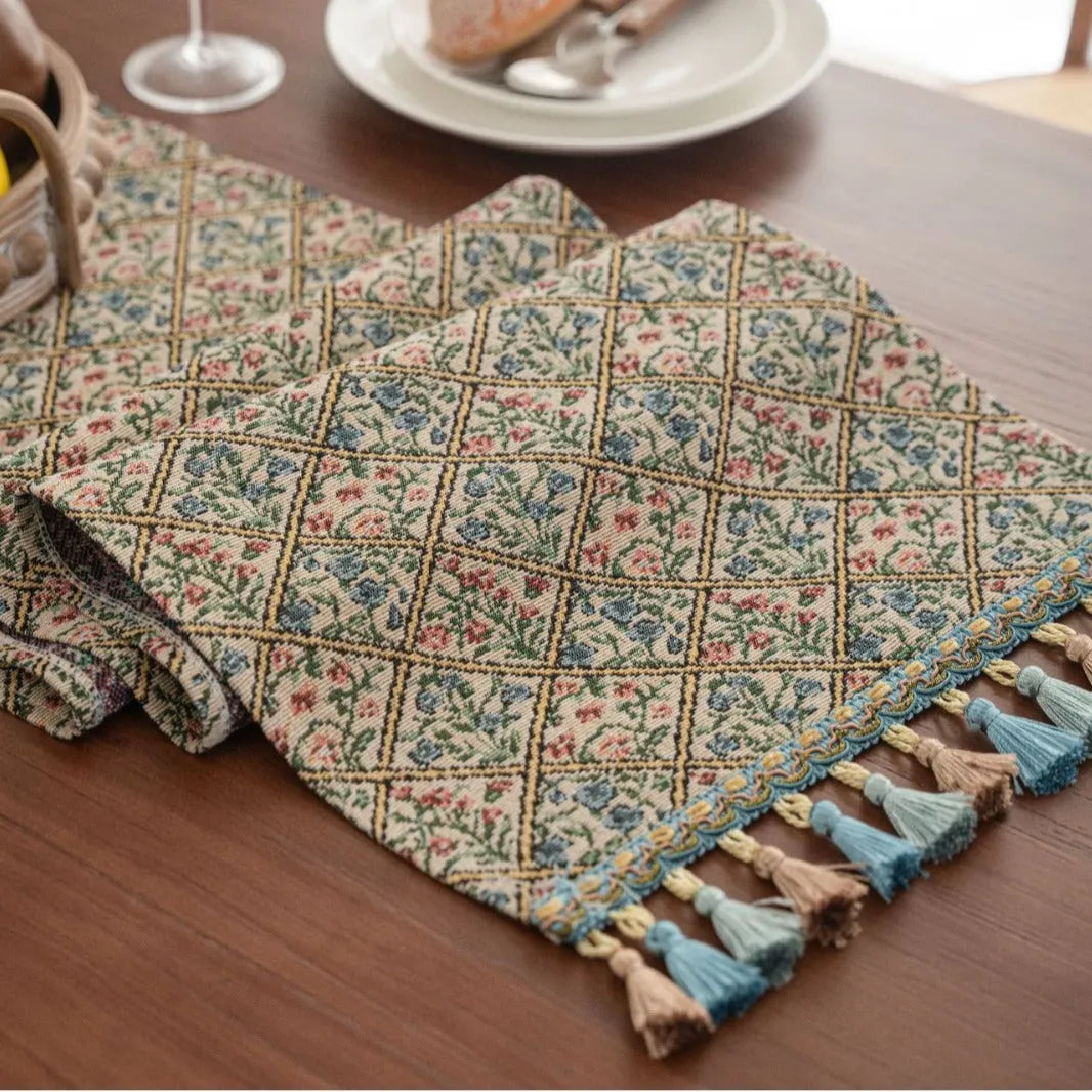 Nordic jacquard bouquet pattern table runner with tassels in dark blue on wooden table