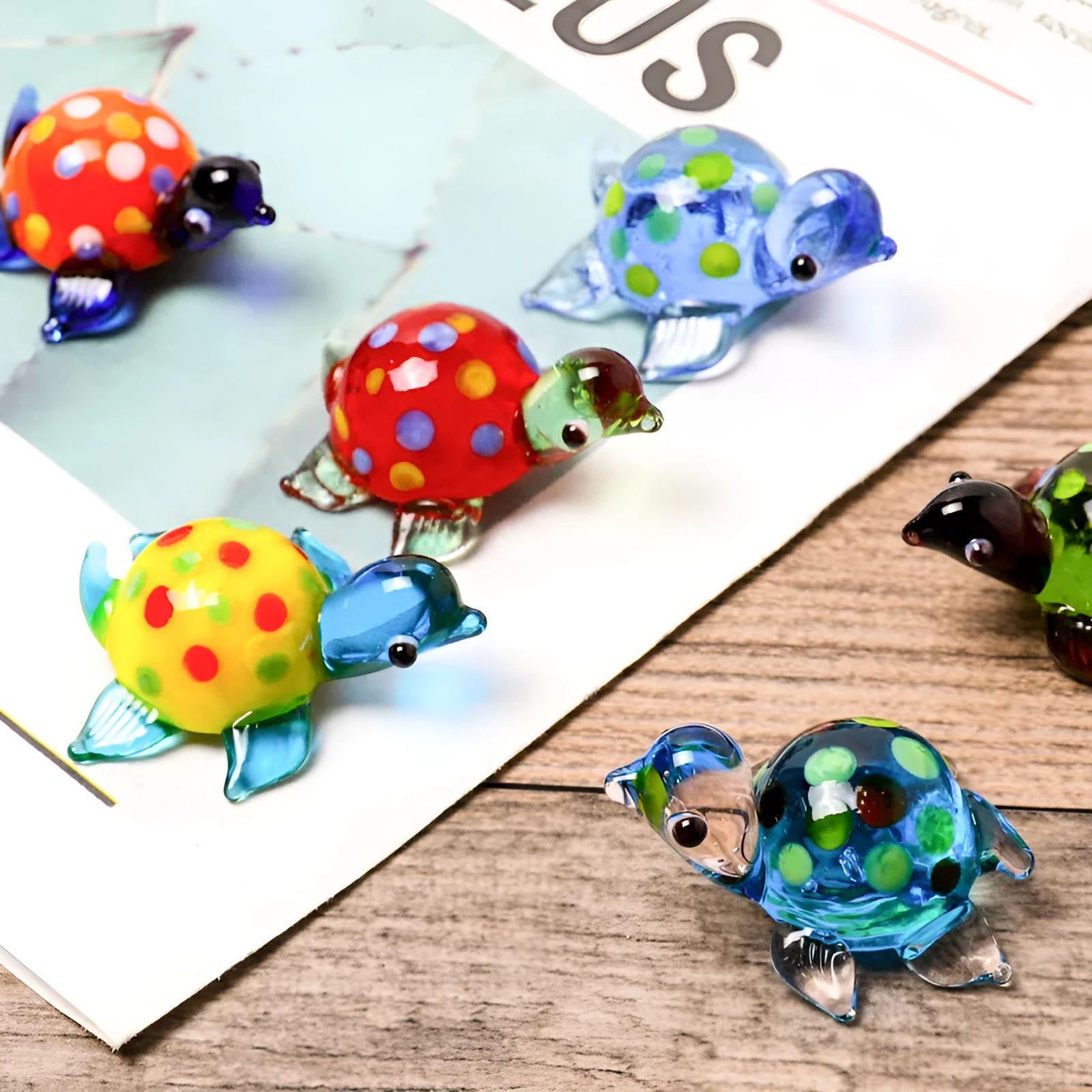 Geometric glass turtle ornament in a modern style displayed on a wooden surface.
