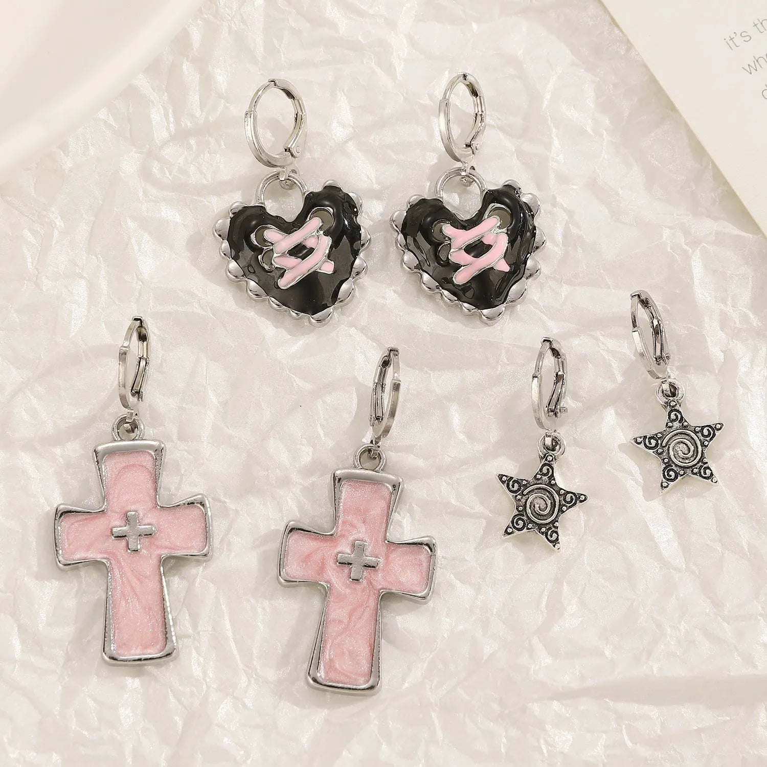 Women's alloy earrings with cross and character designs in five colour options including white cross and antique silver