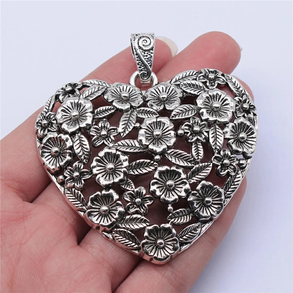Hollow flower love pendant in ancient silver alloy measuring 67x58mm