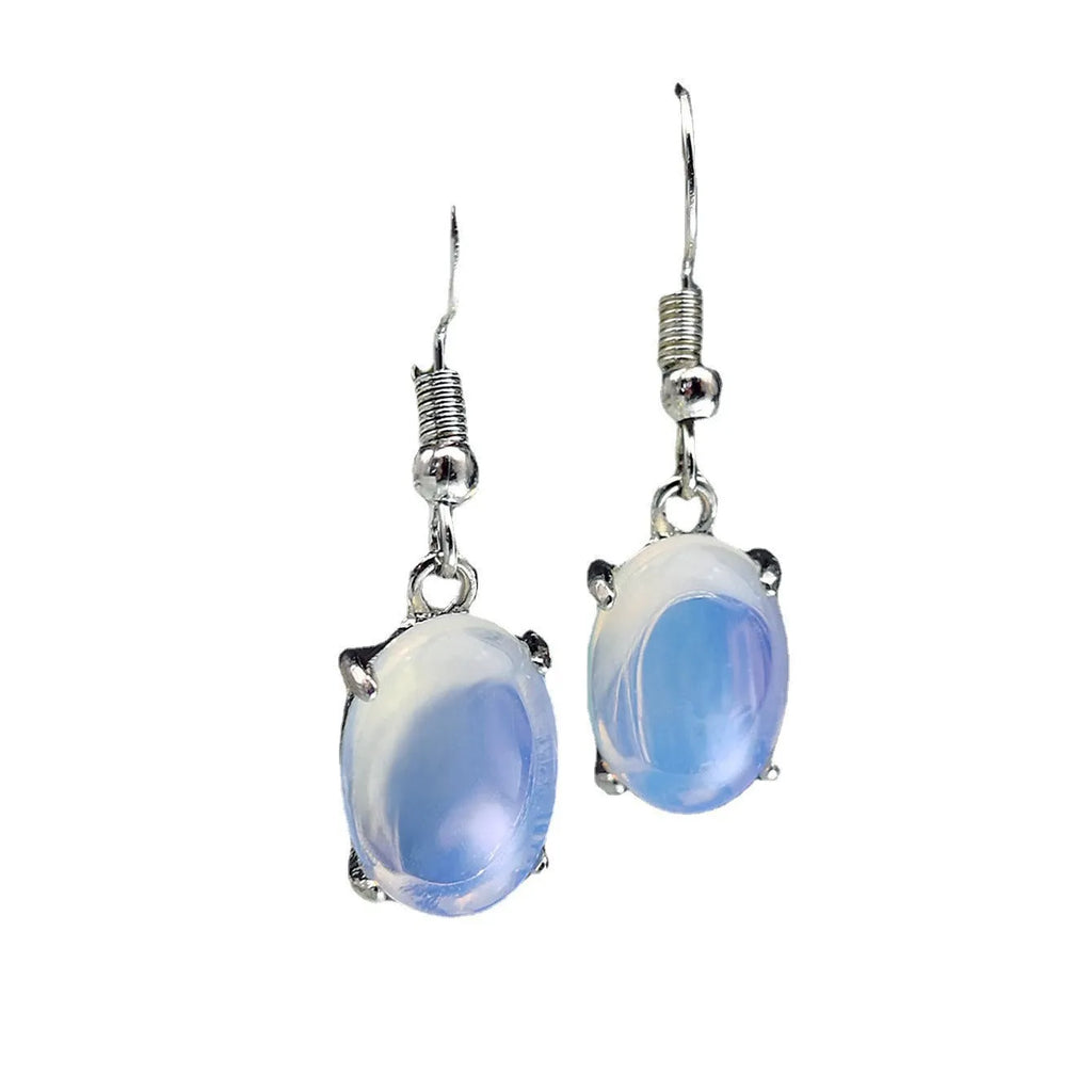 Pair of retro moonstone opal drop earrings with a cross design in moonlight white.
