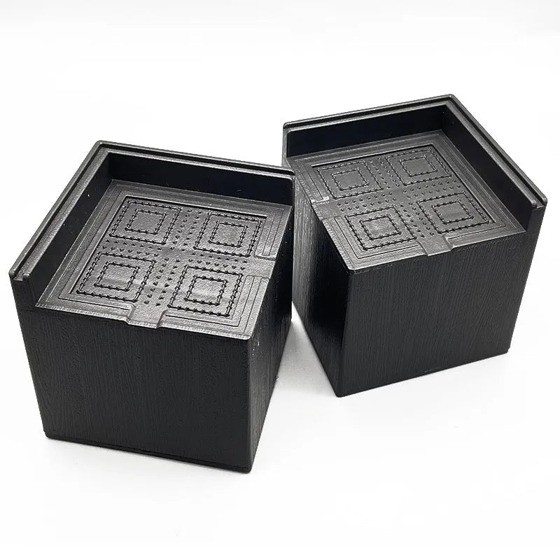 Four black thickened plastic floor mats for furniture leg levelling