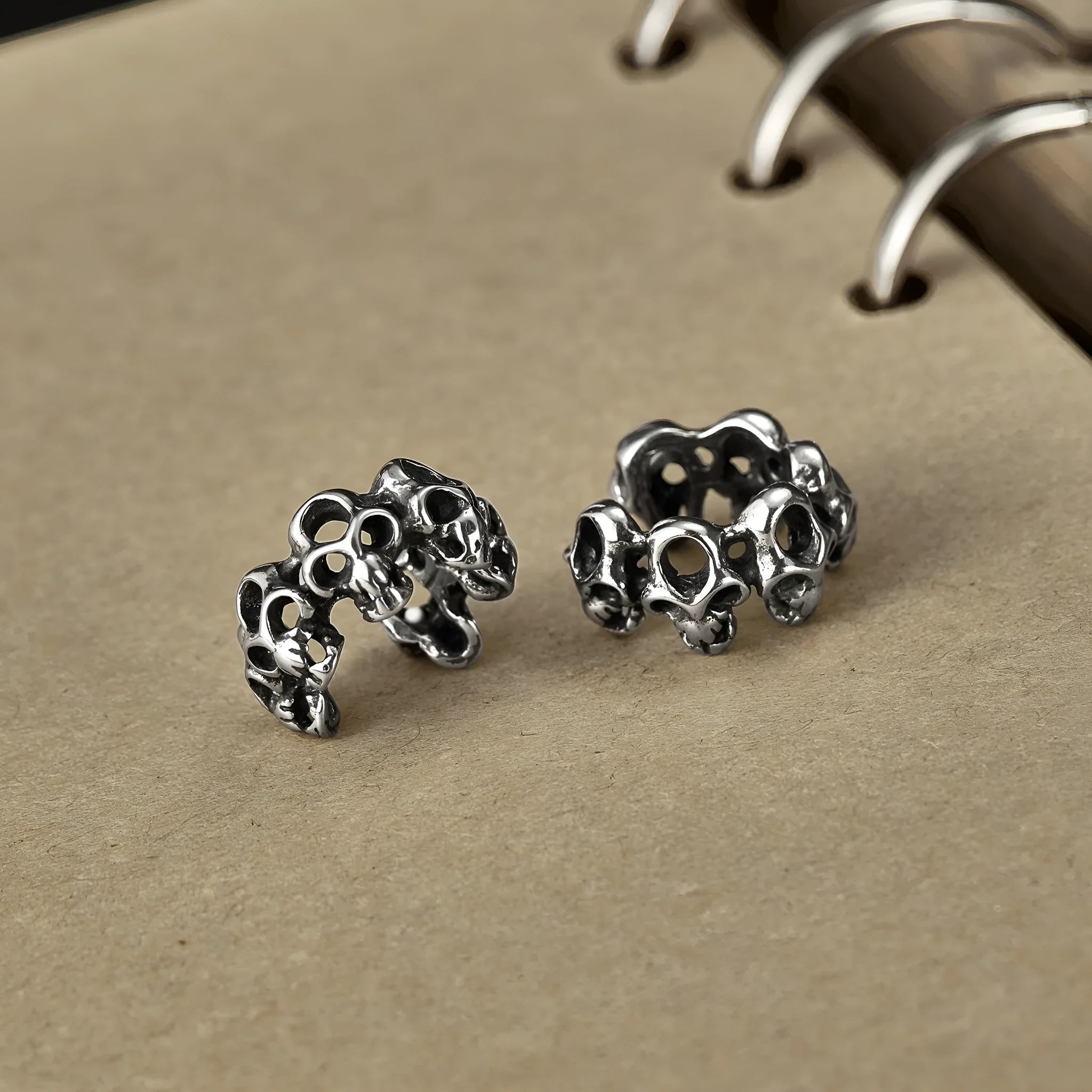 Geometric hollow skull ear clips in stainless steel with electroplated finish