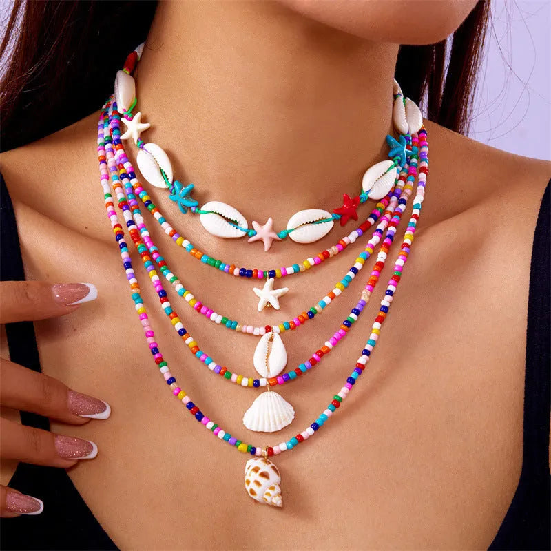 Women's five-piece shell bead necklace set with adjustable length showing blue and coloured variants