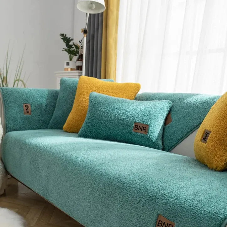 Lambswool solid colour sofa cover in blue on a sofa, showing simple slipcover style.