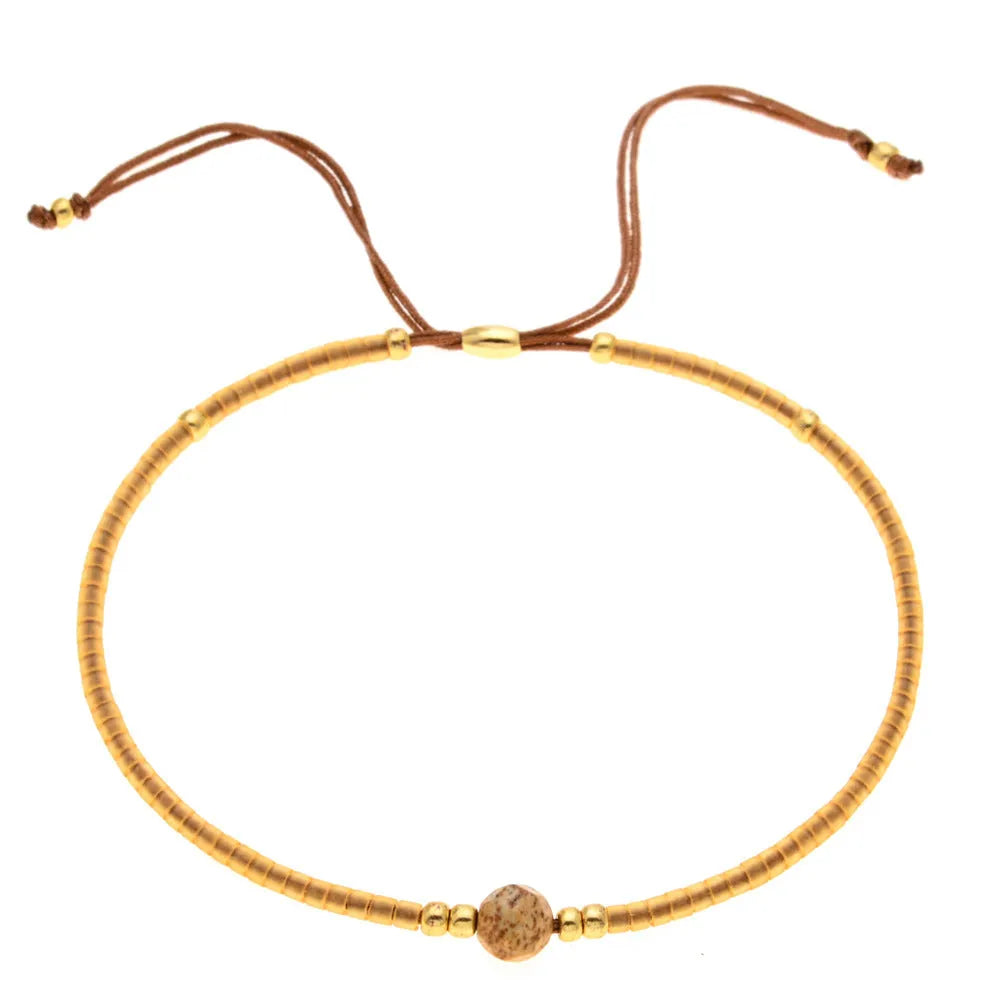 Bohemian style women's bracelet with semi-precious stone and colourful glass beads on adjustable fastening
