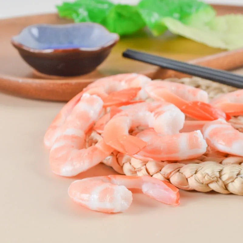 Solid PVC shrimp-shaped keychain with metal loop, 1.5cm thick, modern design.