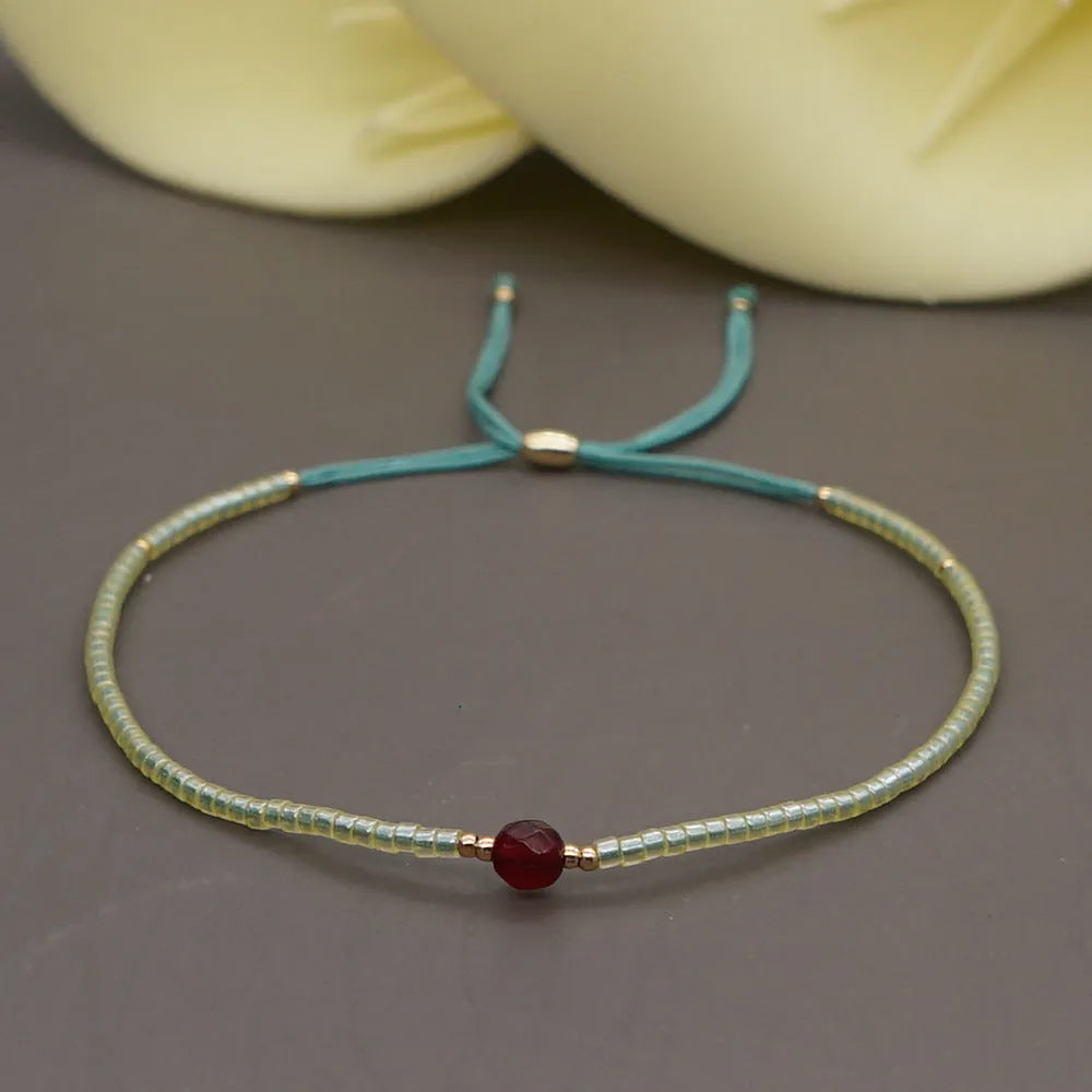 Bohemian style women's bracelet with semi-precious stone and colourful glass beads on adjustable fastening