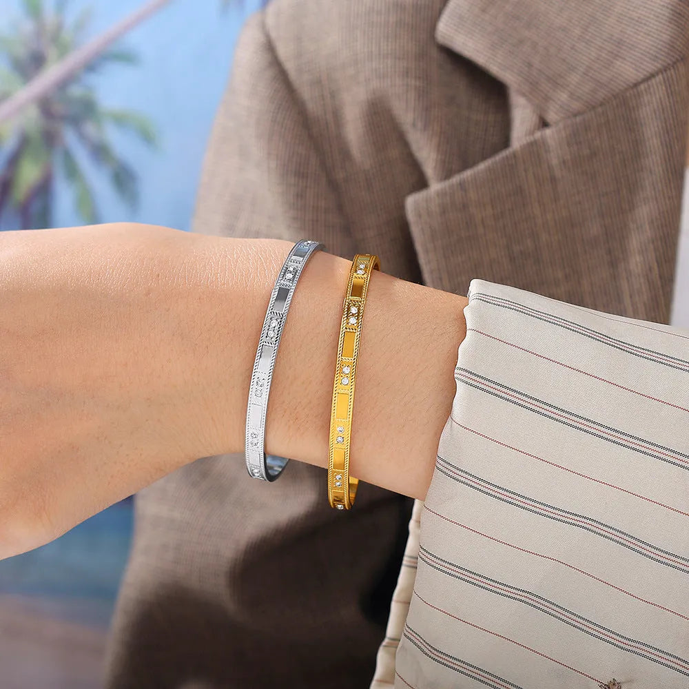 Stainless steel open-end buckle bracelet with electroplated finish, available in gold, white zirconium, and white diamond colours