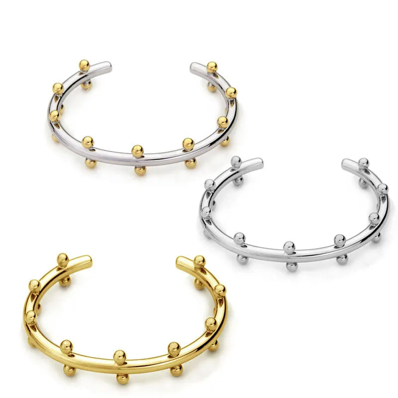 Adjustable C-shaped bracelet with round stainless steel bean beads on an alloy chain.
