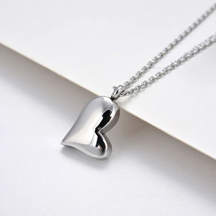 Silver curved peach heart stainless steel pendant necklace on adjustable chain
