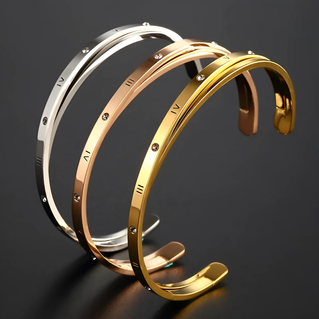 Open-ended stainless steel women's bracelet with inlaid zircon stones in gold colour.