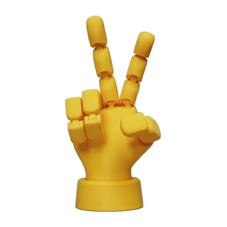 Yellow movable joint hand ornament figurine on a plain background.