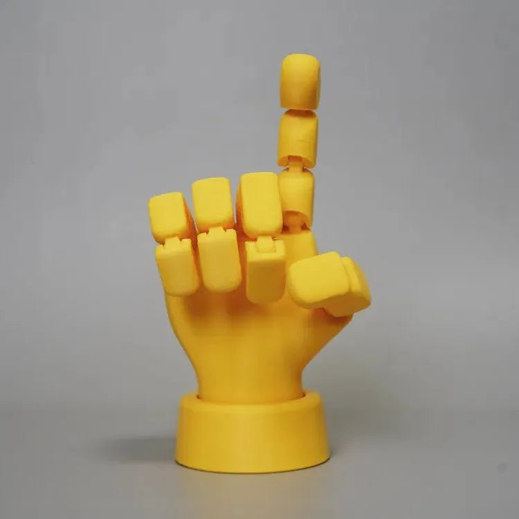 Yellow movable joint hand ornament figurine on a plain background.
