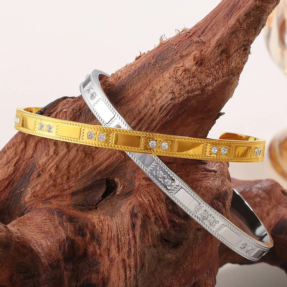 Stainless steel open-end buckle bracelet with electroplated finish, available in gold, white zirconium, and white diamond colours