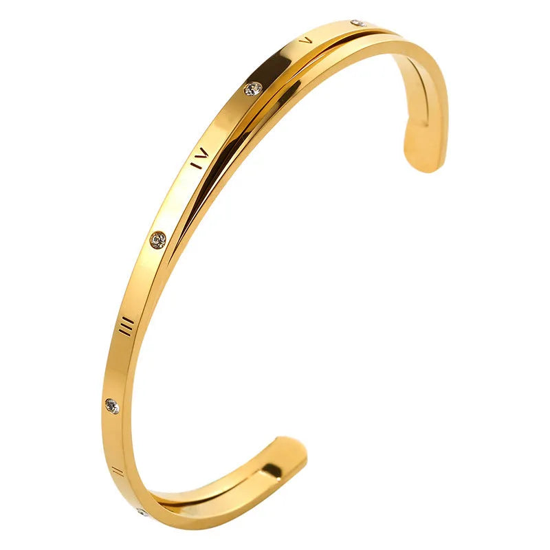Open-ended stainless steel women's bracelet with inlaid zircon stones in gold colour.