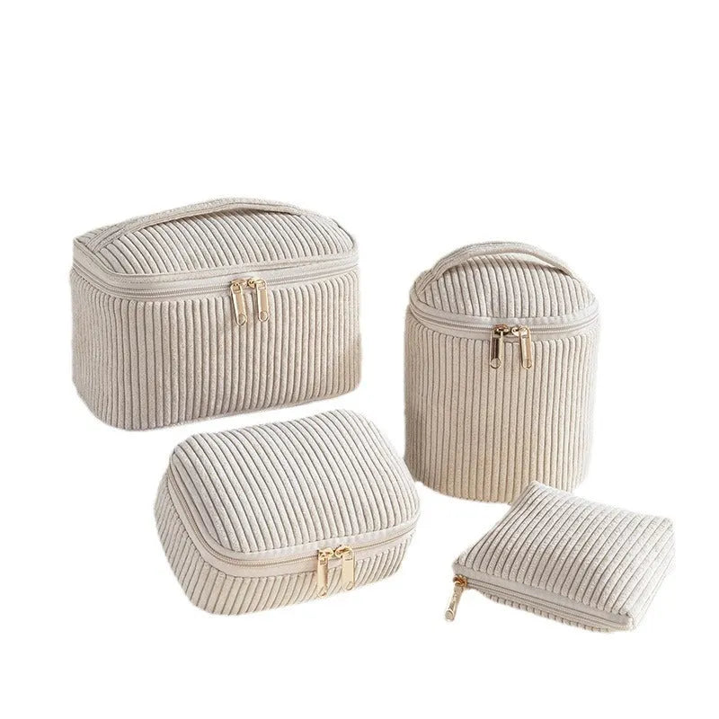 Four cube-style polyester makeup bags in different colour patterns including pink, khaki, and dotted designs