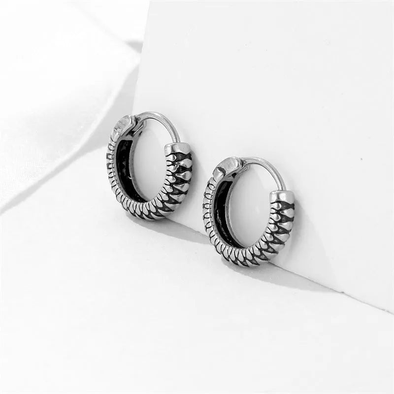 Silver titanium steel geometric twist earrings with round sports-style elements