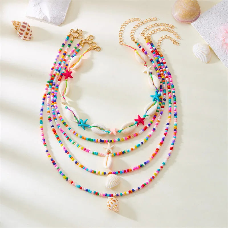 Women's five-piece shell bead necklace set with adjustable length showing blue and coloured variants